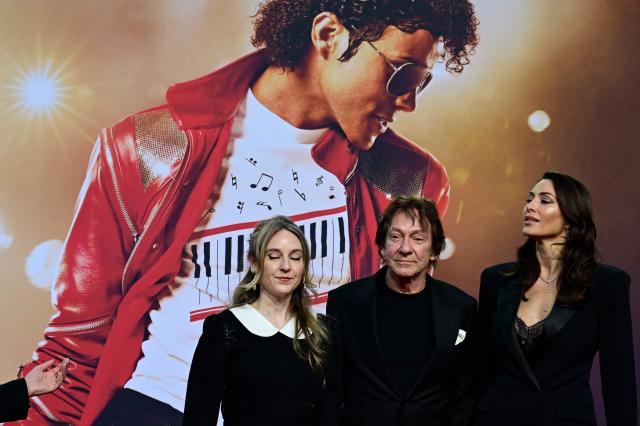 US entertainment lawyer John Branca (C) and guests poses for photogaphers as they arrive on the red carptet for the world premiere of the Michael Jackson biopic "Michael" at the Uber Eats Music Hall in Berlin on April 10, 2026. Thousands of Michael Jackson fans converged on April 10, 2026 to Berlin before the world premiere of the biopic on the king of pop, despite the accusations of paedophilia that still target the artist. (Photo by John MACDOUGALL / AFP)