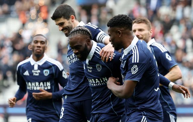 Paris FC's French midfielder #93 Jonathan Ikone (C) is congratulated by teammates after scoring a goal during the French L1 football match between Paris FC and AS Monaco at the Stade Jean-Bouin in Paris on April 10, 2026. (Photo by FRANCK FIFE / AFP)