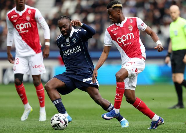 Paris FC's French midfielder #93 Jonathan Ikone (L) fights for the ball with Monaco's Ivorian forward #24 Simon Adingra (R) during the French L1 football match between Paris FC and AS Monaco at the Stade Jean-Bouin in Paris on April 10, 2026. (Photo by FRANCK FIFE / AFP)