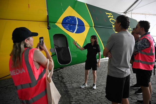 Crew member show parts of the Mubadala Brazil SailGP team vessel during a media tour at Rio de Janeiro Yacht Club, within the Rio 2026 SailGP in Rio de Janeiro, Brazil, on April 10, 2026. (Photo by Mauro PIMENTEL / AFP)