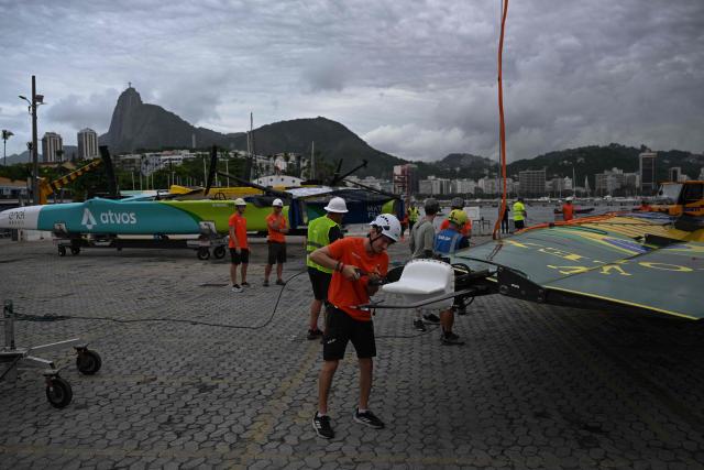 Crew members prepare to lift the wing of the Mubadala Brazil SailGP team vessel at Rio de Janeiro Yacht Club, during the Rio 2026 SailGP in Rio de Janeiro, Brazil, on April 10, 2026. (Photo by Mauro PIMENTEL / AFP)