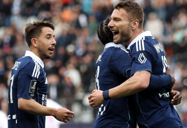 Paris FC's French midfielder #93 Jonathan Ikone (C) celebrates his goal with Paris FC's Italian forward #36 Ciro Immobile (R) during the French L1 football match between Paris FC and AS Monaco at the Stade Jean-Bouin in Paris on April 10, 2026. (Photo by FRANCK FIFE / AFP)