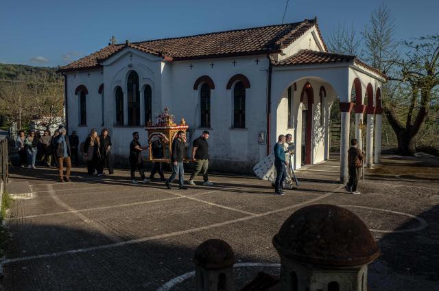 Christians Orthodox worshippers carry the Epitaphios during Good Friday at a church in the village of Dodekametro of region of Arcadia in Greece, on April 10, 2026. (Photo by Angelos TZORTZINIS / AFP)
