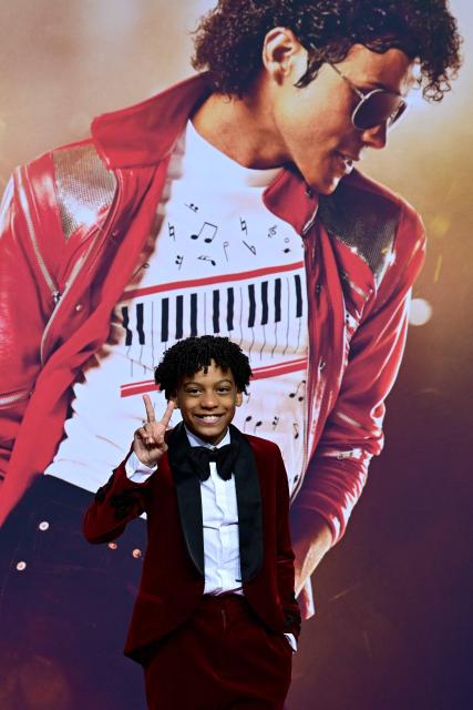 US young actor Juliano Valdi poses for photogaphers as he arrives on the red carpet for the world premiere of the Michael Jackson biopic "Michael" at the Uber Eats Music Hall in Berlin on April 10, 2026. Thousands of Michael Jackson fans converged on April 10, 2026 to Berlin before the world premiere of the biopic on the king of pop, despite the accusations of paedophilia that still target the artist. (Photo by John MACDOUGALL / AFP)