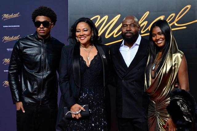 US director Antoine Fuqua (2nd R) poses for photogaphers with other guests as he arrives on the red carpet for the world premiere of the Michael Jackson biopic "Michael" at the Uber Eats Music Hall in Berlin on April 10, 2026. Thousands of Michael Jackson fans converged on April 10, 2026 to Berlin before the world premiere of the biopic on the king of pop, despite the accusations of paedophilia that still target the artist. (Photo by John MACDOUGALL / AFP)