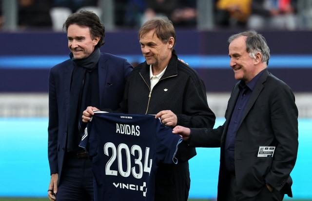 French representative of the Agache family holding company, Antoine Arnault (L), Chief Executive Officer of German sportswear giant Adidas, Bjoern Gulden and Paris FC's French president Pierre Ferracci pose during the French L1 football match between Paris FC and AS Monaco at the Stade Jean-Bouin in Paris on April 10, 2026. (Photo by FRANCK FIFE / AFP)