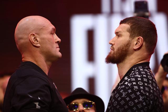 Britain's Tyson Fury faces off with Russia's Arslanbek Makhmudov during a ceremonial weigh-in in central London on April 10, 2026, ahead of their heavyweight boxing match on April 11. (Photo by Henry Nicholls / AFP)