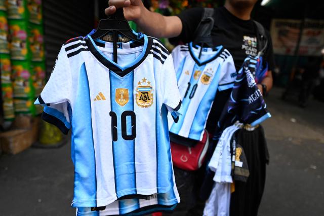 A vendor offers replicas of the Argentina's national football team jersey at La Terminal market in Guatemala City on April 10, 2026. (Photo by JOHAN ORDONEZ / AFP)