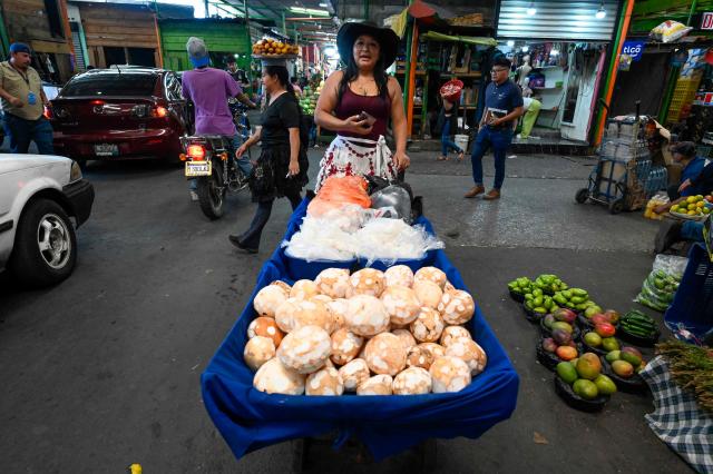 A woman waits for customers at La Terminal market in Guatemala City on April 10, 2026. (Photo by JOHAN ORDONEZ / AFP)