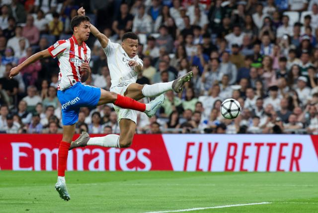 Real Madrid's French forward #10 Kylian Mbappe (R) is challenged by Girona's Brazilian defender #12 Vitor Reis during the Spanish league football match between Real Madrid CF and Girona FC at the Santiago Bernabeu stadium in Madrid on April 10, 2026. (Photo by Thomas COEX / AFP)