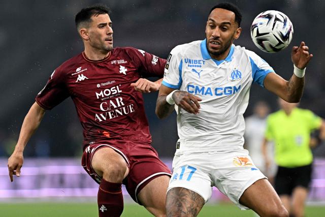 Metz's French defender #02 Maxime Colin vies with Marseille's Gabonese forward #17 Pierre-Emerick Aubameyang (R) during the French L1 football match between Olympique de Marseille (OM) and Metz FC at the Stade Velodrome in Marseille, southern France on April 10, 2026. (Photo by Gabriel BOUYS / AFP)