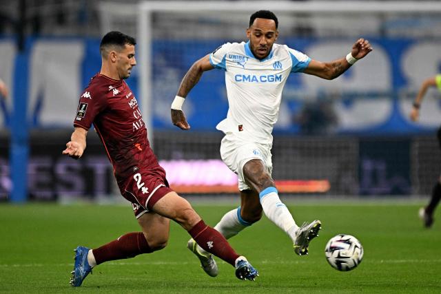 Metz's French defender #02 Maxime Colin vies with Marseille's Gabonese forward #17 Pierre-Emerick Aubameyang (R) during the French L1 football match between Olympique de Marseille (OM) and Metz FC at the Stade Velodrome in Marseille, southern France on April 10, 2026. (Photo by Gabriel BOUYS / AFP)
