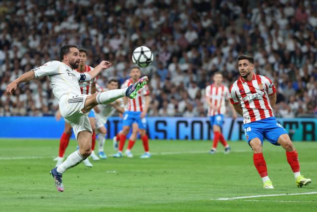 Real Madrid's Spanish defender #02 Dani Carvajal (L) controls the ball in front of Girona's Spanish defender #24 Alexandre Moreno during the Spanish league football match between Real Madrid CF and Girona FC at the Santiago Bernabeu stadium in Madrid on April 10, 2026. (Photo by Thomas COEX / AFP)