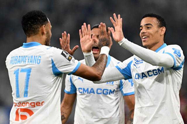 Marseille's Gabonese forward #17 Pierre-Emerick Aubameyang is congratulated by Marseille's English forward #10 Mason Greenwood (R) after scoring a goal during the French L1 football match between Olympique de Marseille (OM) and Metz FC at the Stade Velodrome in Marseille, southern France on April 10, 2026. (Photo by Gabriel BOUYS / AFP)