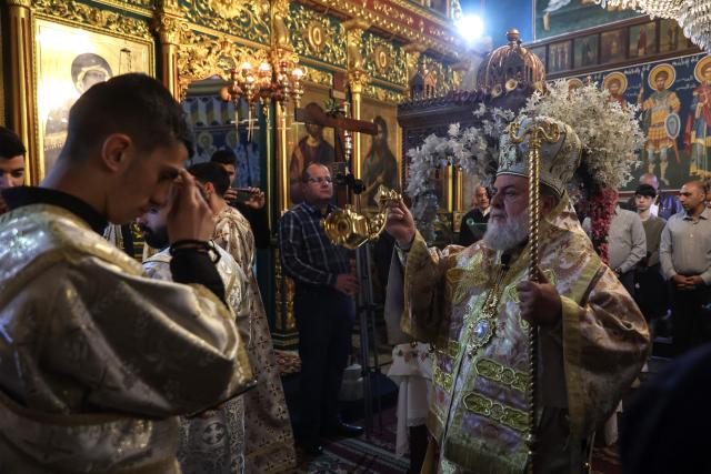 Archbishop Alexios (R) leads Good Friday mass at the Greek Orthodox church of Saing Porphyrius in Gaza City on April 10, 2026. (Photo by Omar AL-QATTAA / AFP)