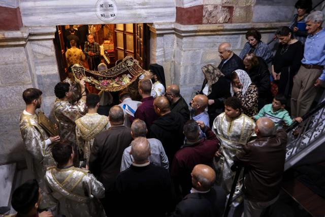 People attend Good Friday mass at the Greek Orthodox church of Saing Porphyrius in Gaza City on April 10, 2026. (Photo by Omar AL-QATTAA / AFP)