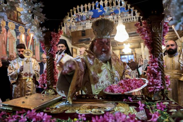 Archbishop Alexios decorates the Epitaph as he leads Good Friday mass at the Greek Orthodox church of Saing Porphyrius in Gaza City on April 10, 2026. (Photo by Omar AL-QATTAA / AFP)