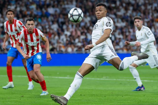 Real Madrid's French forward #10 Kylian Mbappe eyes the ball as he prepares to shoot during the Spanish league football match between Real Madrid CF and Girona FC at the Santiago Bernabeu stadium in Madrid on April 10, 2026. (Photo by Thomas COEX / AFP)