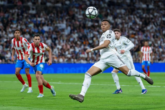Real Madrid's French forward #10 Kylian Mbappe eyes the ball as he prepares to shoot during the Spanish league football match between Real Madrid CF and Girona FC at the Santiago Bernabeu stadium in Madrid on April 10, 2026. (Photo by Thomas COEX / AFP)