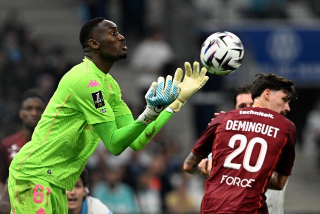 Metz's Senegalese goalkeeper #61 Pape Sy catches the ball during the French L1 football match between Olympique de Marseille (OM) and Metz FC at the Stade Velodrome in Marseille, southern France on April 10, 2026. (Photo by Gabriel BOUYS / AFP)