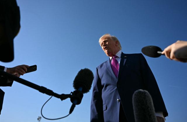 US President Donald Trump speaks to journalists before boarding Air Force One at Joint Base Andrews, Maryland on April 10, 2026. President Trump is flying to Charlottesville, Virginia to attend a MAGA inc. meeting and dinner at Trump Winery. (Photo by Jim WATSON / AFP)