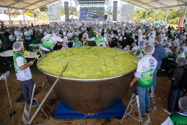 Participants prepare 6,800 kilos of Guacamole, a traditional Mexican dish made from avocados, tomatoes, onions, limes and coriander in Tancitaro, Michoacan state, Mexico on April 10, 2026. 800 people used 12 tons of avocados to complete the task on an attempt to break the Guinness World Record for the largest guacamole. Tancitaro is recognized as the "Avocado Capital," and the leading exporter of avocados to the US. (Photo by Enrique Castro / AFP)