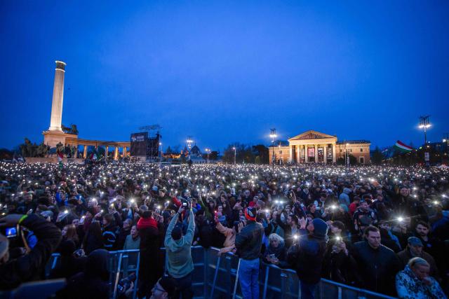 People attend the so-called concert ‘Rendszerbonto’ (“Demolition of the System”), which features more than 40 artists and is organized by the citizen resistance movement on Heroes’ Square in Budapest on April 10, 2026, two days before general elections. (Photo by Ferenc ISZA / AFP)