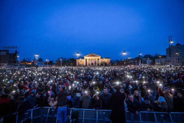 People attend the so-called concert ‘Rendszerbonto’ (“Demolition of the System”), which features more than 40 artists and is organized by the citizen resistance movement on Heroes’ Square in Budapest on April 10, 2026, two days before general elections. (Photo by Ferenc ISZA / AFP)