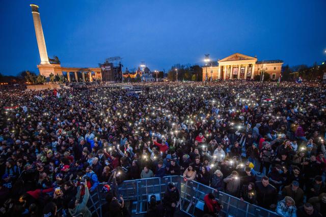 People attend the so-called concert ‘Rendszerbonto’ (“Demolition of the System”), which features more than 40 artists and is organized by the citizen resistance movement on Heroes’ Square in Budapest on April 10, 2026, two days before general elections. (Photo by Ferenc ISZA / AFP)