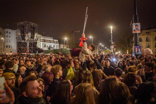 People attend the so-called concert ‘Rendszerbonto’ (“Demolition of the System”), which features more than 40 artists and is organized by the citizen resistance movement on Heroes’ Square in Budapest on April 10, 2026, two days before general elections. (Photo by Ferenc ISZA / AFP)