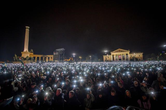 People attend the so-called concert ‘Rendszerbonto’ (“Demolition of the System”), which features more than 40 artists and is organized by the citizen resistance movement on Heroes’ Square in Budapest on April 10, 2026, two days before general elections. (Photo by Ferenc ISZA / AFP)