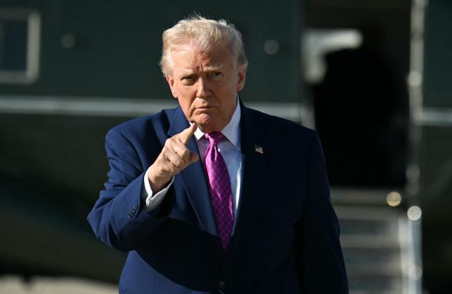 US President Donald Trump gestures after stepping off Marine One at Joint Base Andrews, Maryland on April 10, 2026. President Trump is flying to Charlottesville, Virginia to attend a MAGA inc. meeting and dinner at Trump Winery. (Photo by Jim WATSON / AFP)