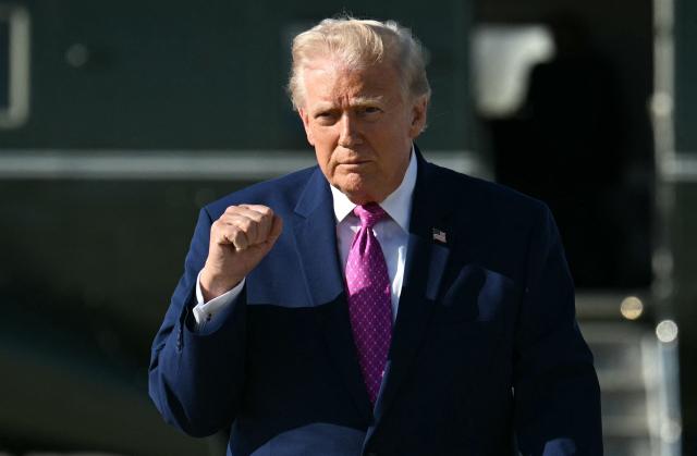 US President Donald Trump gestures after stepping off Marine One at Joint Base Andrews, Maryland on April 10, 2026. President Trump is flying to Charlottesville, Virginia to attend a MAGA inc. meeting and dinner at Trump Winery. (Photo by Jim WATSON / AFP)