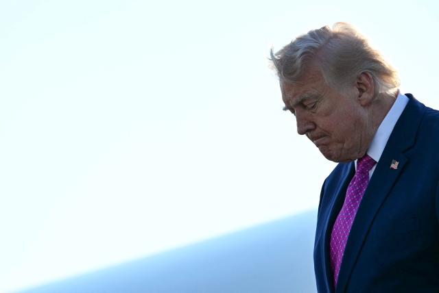 US President Donald Trump steps off Air Force One at Charlottesville-Albemarle Airport, Virginia on April 10, 2026. President Trump is in Charlottesville, Virginia to attend a MAGA inc. meeting and dinner at Trump Winery. (Photo by Jim WATSON / AFP)