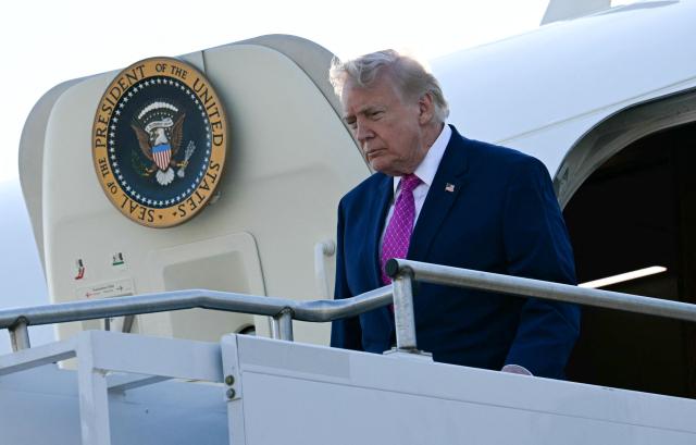US President Donald Trump steps off Air Force One at Charlottesville-Albemarle Airport, Virginia on April 10, 2026. President Trump is in Charlottesville, Virginia to attend a MAGA inc. meeting and dinner at Trump Winery. (Photo by Jim WATSON / AFP)