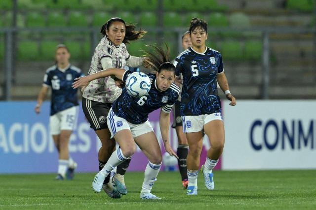 Chile's forward #16 Adriana Moreno (L), Argentina's defender #06 Aldana Cometti and midfielder #05 Vanina Preininger fight for the ball during the CONMEBOL Nations League Women football match between Chile and Argentina at the Elias Figueroa stadium in Valparaiso, Chile on April 10, 2026. (Photo by Rodrigo ARANGUA / AFP)