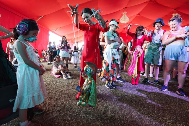 Puppeteers from the Bob Baker Marionette Theater perform in the crowd during the 2026 Coachella Valley Music and Arts Festival in Indio, California on April 10, 2026. (Photo by VALERIE MACON / AFP)