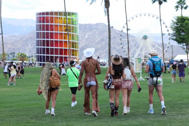 Festival-goers walk during the 2026 Coachella Valley Music and Arts Festival in Indio, California on April 10, 2026. (Photo by VALERIE MACON / AFP)