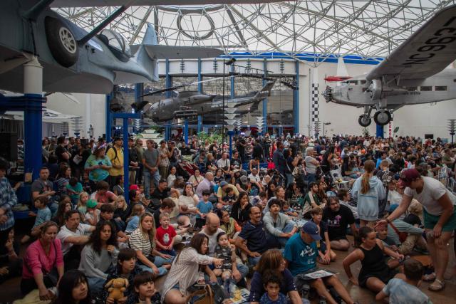 People watch a live broadcast of the return of the Artemis II crew members to Earth at the San Diego Air and Space Museum during a watch party for the crew's splash down in the Pacific Ocean, in San Diego, California, on April 10, 2026. The NASA spacecraft carrying four astronauts splashed down as planned Friday off the California coast, capping the US space agency's successful crewed test mission around the Moon, the first such flyby in more than 50 years. Mission commander Reid Wiseman reported that the crewmembers -- himself along with Christina Koch, Victor Glover and Jeremy Hansen -- were "stable" and "green." (Photo by Apu GOMES / AFP)