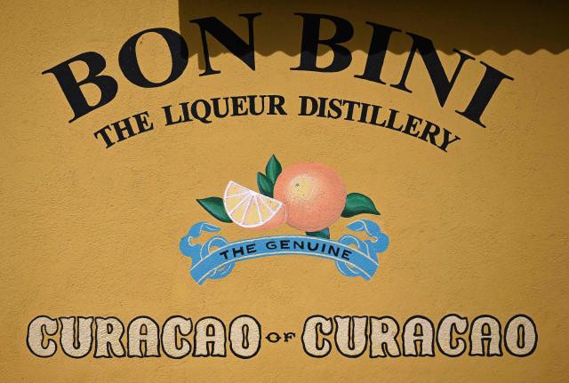 View of the logo at The Curacao Liqueur Distillery in Willemstad, Curacao, in the Dutch Caribbean, on April 9, 2026. The iconic blue color of Curaзao liquor is not natural; it is obtained by adding a coloring agent designed to evoke the turquoise waters of the island’s idyllic Caribbean beaches. (Photo by Raul ARBOLEDA / AFP)
