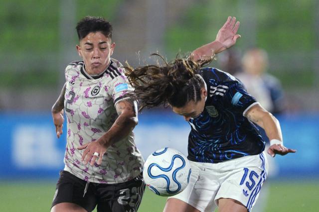 Chile's defender #22 Valentina Diaz and Argentina's defender #15 Maria Bonsegundo fight for the ball during the CONMEBOL Nations League Women football match between Chile and Argentina at the Elias Figueroa stadium in Valparaiso, Chile on April 10, 2026. (Photo by Rodrigo ARANGUA / AFP)