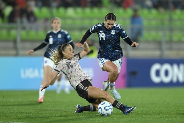 Chile's midfielder #10 Yanara Aedo and Argentina's forward #19 Agostina Holzheier fight for the ball during the CONMEBOL Nations League Women football match between Chile and Argentina at the Elias Figueroa stadium in Valparaiso, Chile on April 10, 2026. (Photo by Rodrigo ARANGUA / AFP)