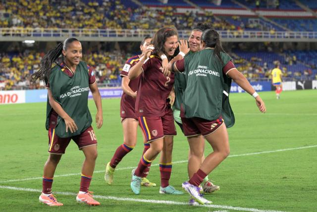 Venezuela's defender #02 Veronica Herrera celebrates with teammates after scoring her team's first goal during the CONMEBOL Nations League Women football match between Colombia and Venezuela at the Olímpico Pascual Guerrero stadium in Cali, Valle del Cauca, Colombia, on April 10, 2026. (Photo by Joaquin SARMIENTO / AFP)