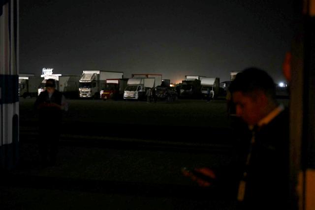 Trucks loaded with voting materials are parked at Peru's National Office of Electoral Processes (ONPE) facilities in Lima on April 10, 2026. (Photo by Luis ROBAYO / AFP)