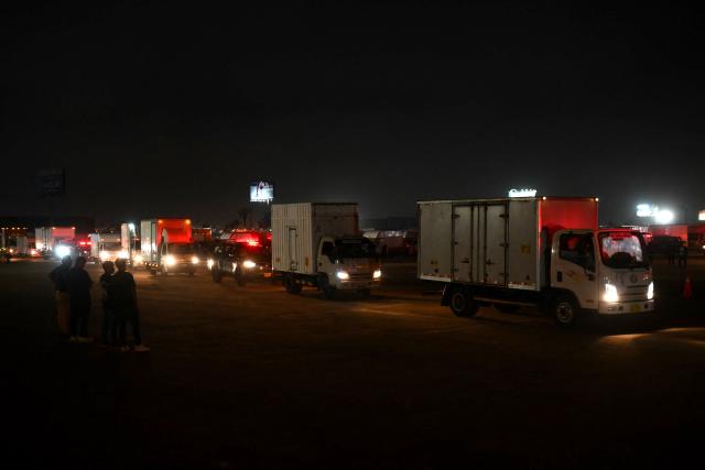 Trucks carry election materials escorted by Peru's police vehicles ahead of the presidential election in Lima on April 10, 2026. Peru will hold presidential elections on April 12. (Photo by Luis ROBAYO / AFP)