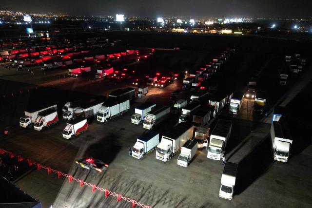 This aerial view shows trucks carrying election materials ahead of the Peru's presidential election at National Office of Electoral Processes (ONPE) facilities in Lima on April 10, 2026. Peru will hold presidential elections on April 12. (Photo by Luis ROBAYO / AFP)