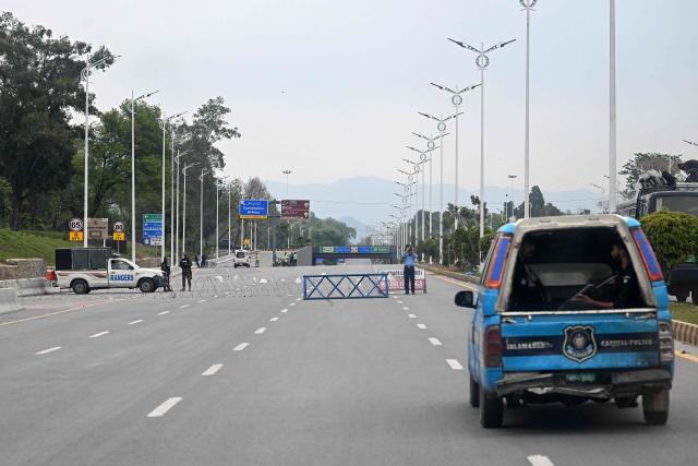 Security personnel stand along a closed street in the Red Zone area ahead of US–Iran peace talks in Islamabad on April 11, 2026. US Vice President JD Vance was en route to Islamabad on April 11 for talks with Iran that the Pakistani premier hosting the warring sides called a "make or break" effort to permanently halt weeks of fighting in the Middle East. (Photo by Aamir QURESHI / AFP)