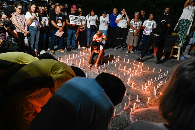 People hold a vigil demanding the release of Venezuelan political prisoners in front of El Rodeo I prison in Guatire, Miranda state, Venezuela on April 10, 2026. (Photo by Maryorin Mendez / AFP)