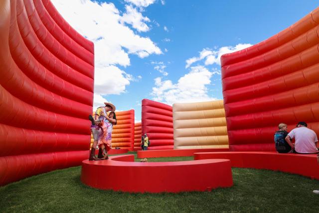 Festival-goers dance in the maze structure during the 2026 Coachella Valley Music and Arts Festival at the Empire Polo Club in Indio, California on April 10, 2026. (Photo by VALERIE MACON / AFP)