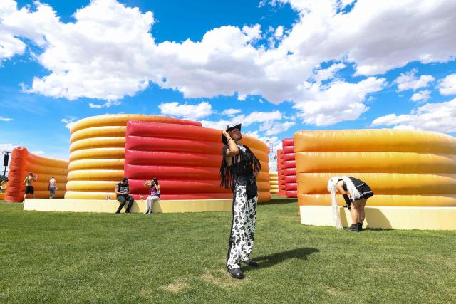 Festival-goers stand in front of the maze structure during the 2026 Coachella Valley Music and Arts Festival at the Empire Polo Club in Indio, California on April 10, 2026. (Photo by VALERIE MACON / AFP)